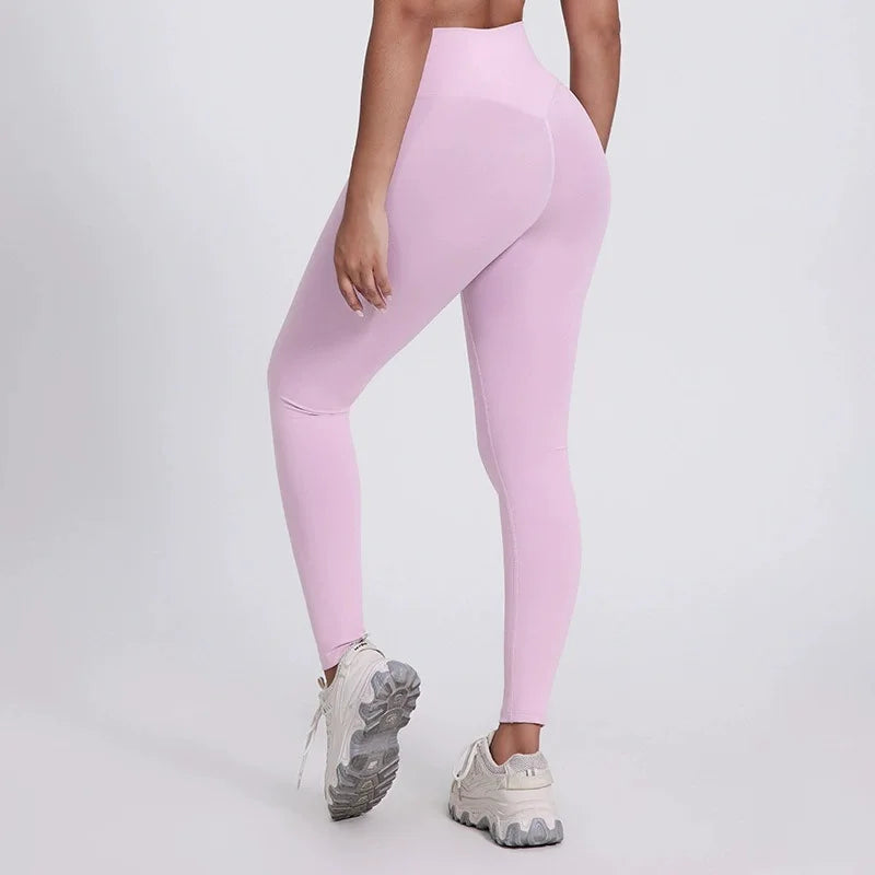 Person wearing light pink leggings on a plain background brand Gymelle