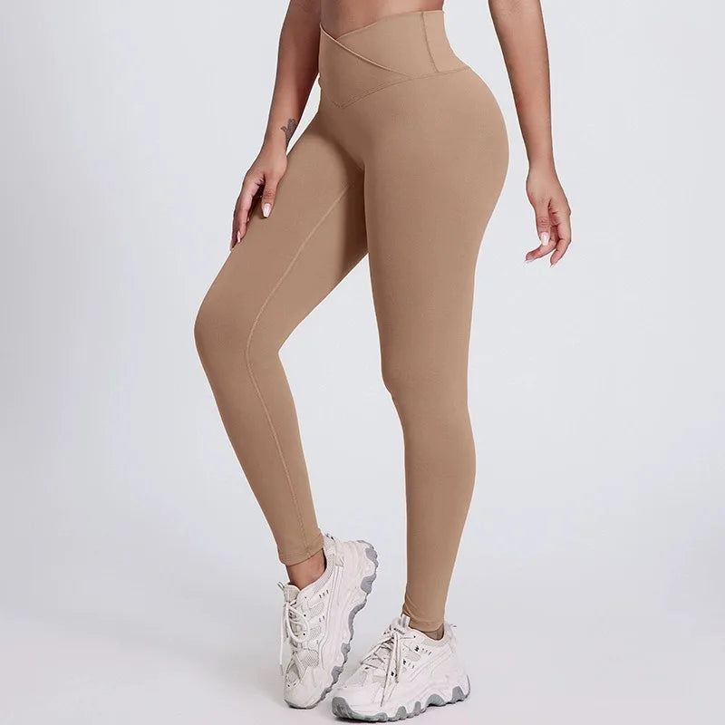 Beige leggings worn by a person on a white background